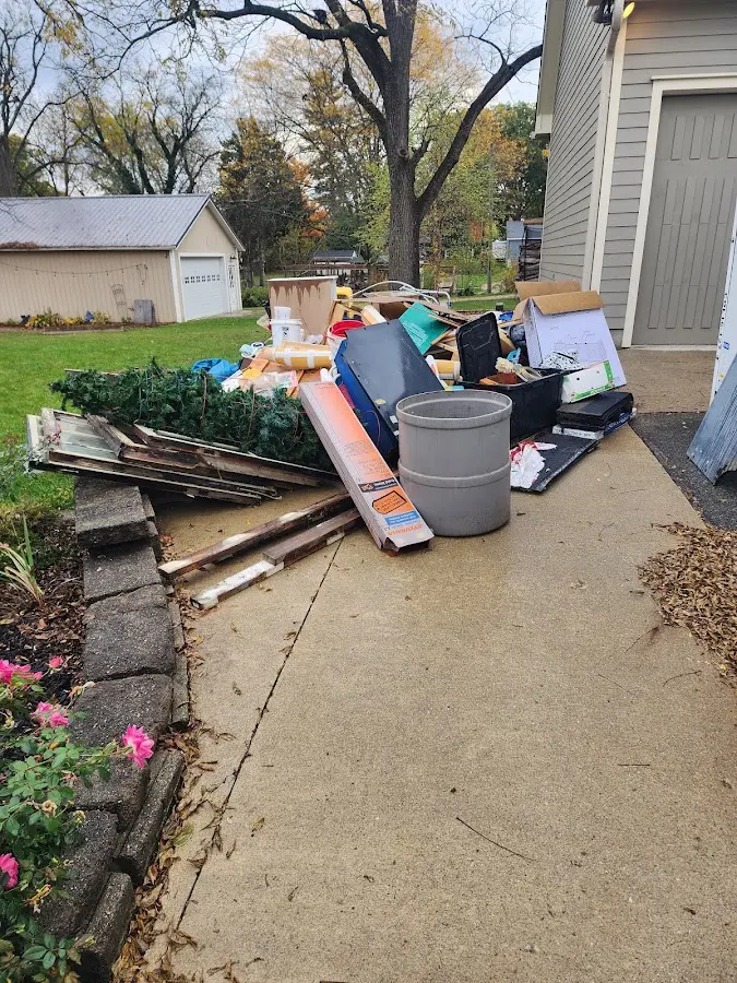 Dumpster being loaded with debris for 12 Yard Dumpster Rental in Dover
